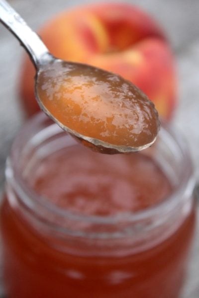 peach jelly spooned over a jar
