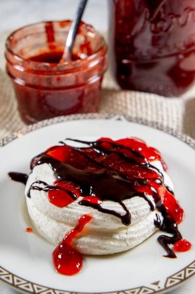 mini pavlova with strawberry jam and chocolate sauce