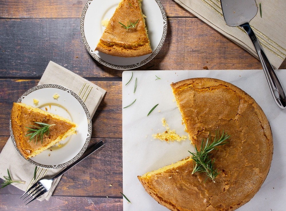 A cake with two slices cut out and placed on small plates