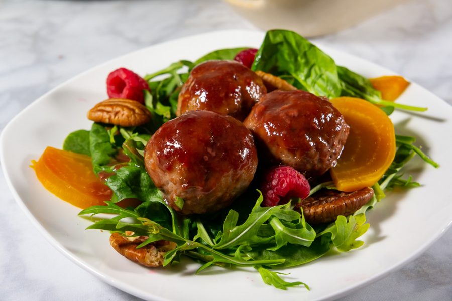 Green salad with golden beets and three glazed meatballs