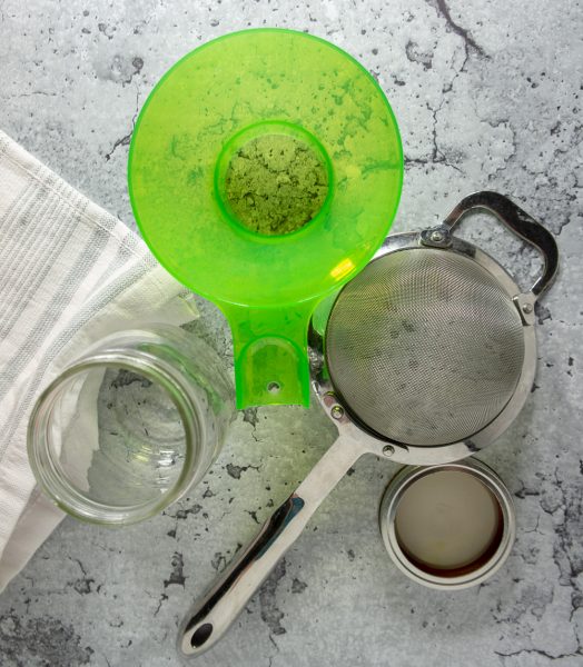 a wide mouth funnel, a sieve, and a jar