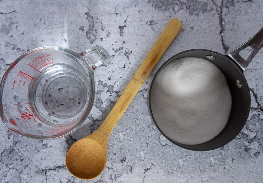 a pot of sugar and a measuring cup of water