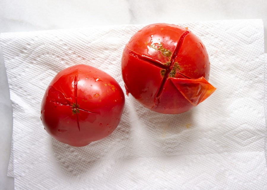 tomatoes after blanching with the skin peeling off