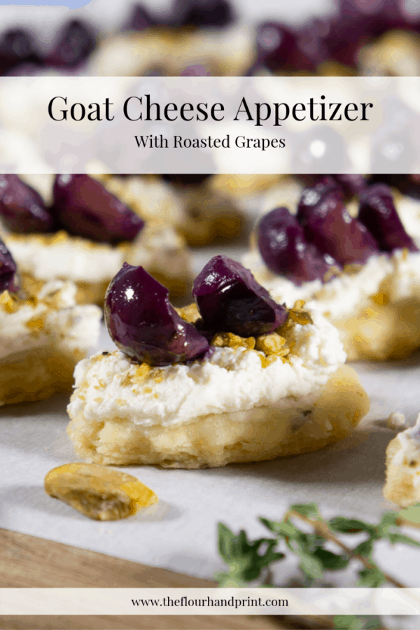 close up of a homemade cracker topped with goat cheese, pistachios, and roasted grapes