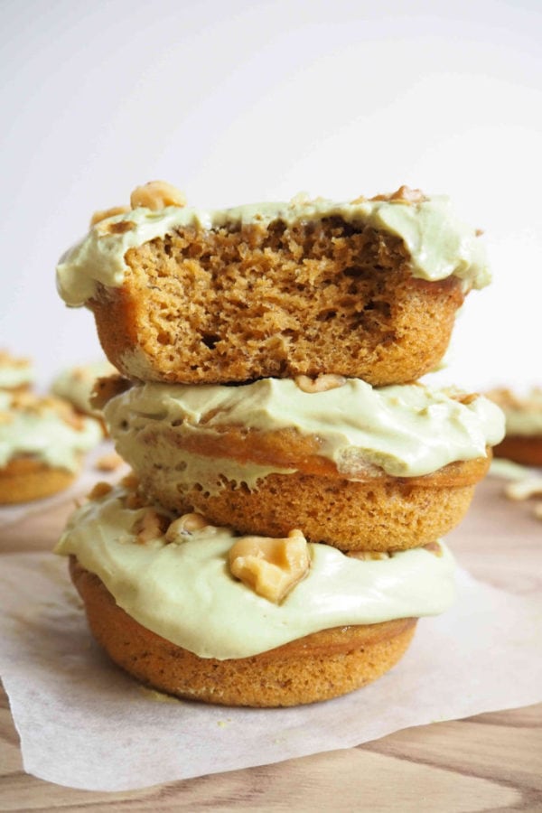 a stack of banana doughnuts with whipped matcha frosting