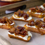 bacon jam crostinis on a serving tray