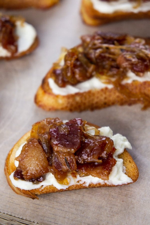 two bacon jam crostini appetizers on parchment paper