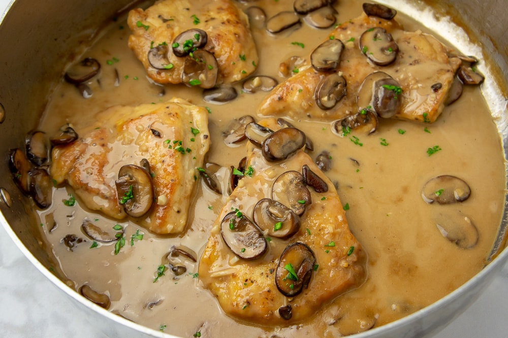 A big pot of chicken in a creamy mushroom marsala sauce