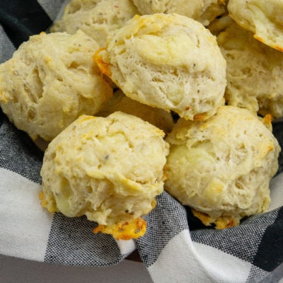 a black checkered napkin full of asiago biscuits