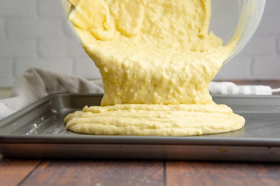 pancake batter being poured onto a sheet pan