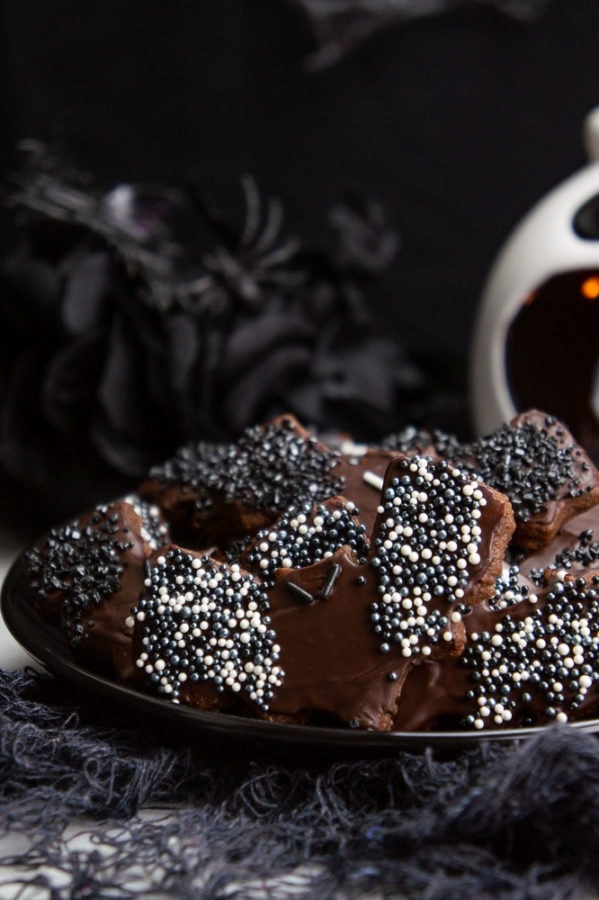 a plate of chocolate bat sugar cookies with sprinkles