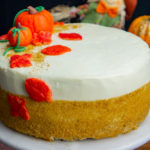a pumpkin layer cake with gold sprinkles and pumpkin decorations