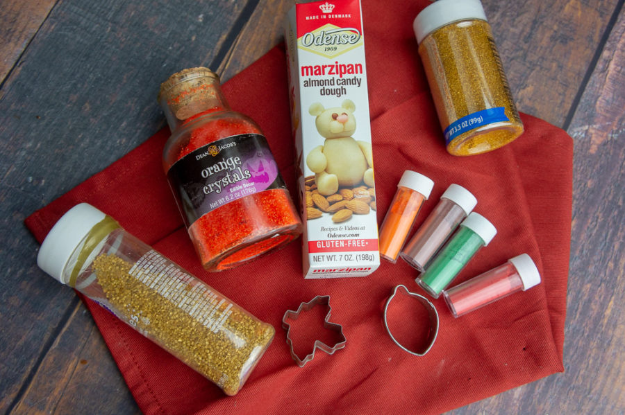 powdered food dye tubes, a box of marzipan and gold sprinkles