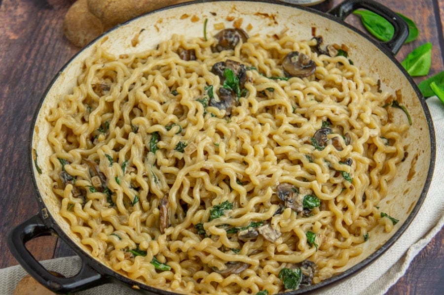 Large pot of pasta with spinach and mushrooms