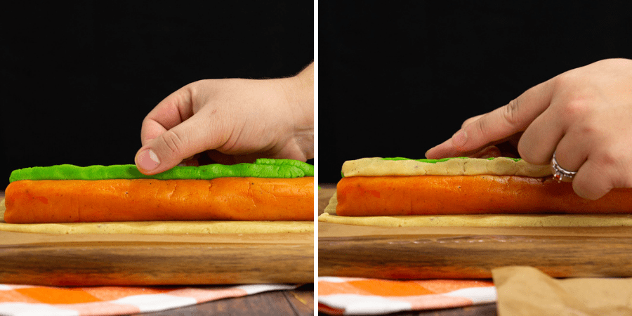 the green stem being fitted on the orange pumpkin dough, then it being reinforced with plain dough