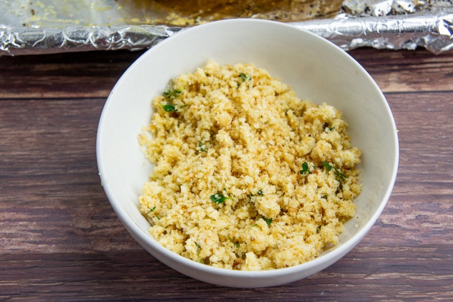 a bowl of breadcrumbs, thyme, and grated cheese