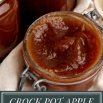 a jar of apple butter open on a white towel