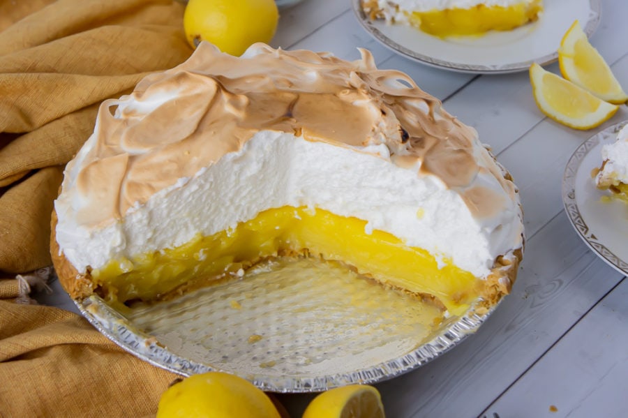 a lemon meringue pie with several slices cut away from it