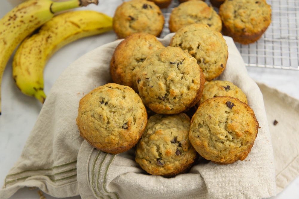 a bowl piled with banana oat muffins