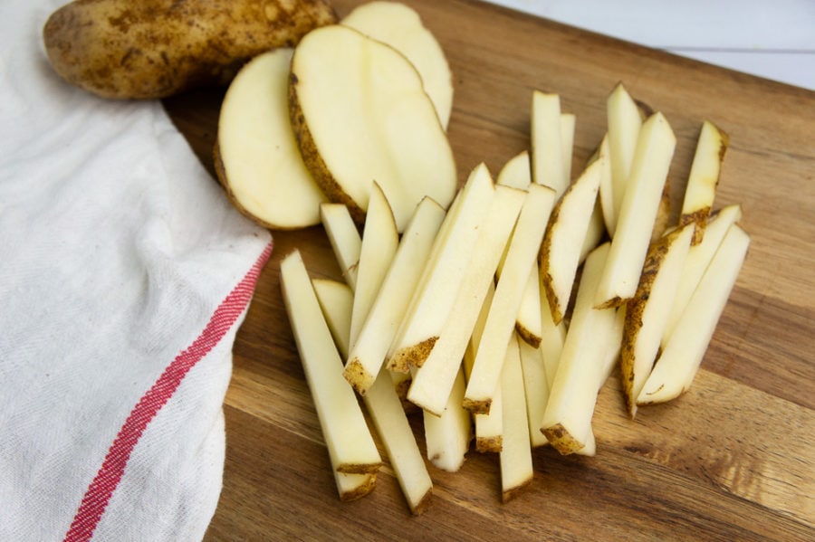 russet potatoes sliced on a cutting board