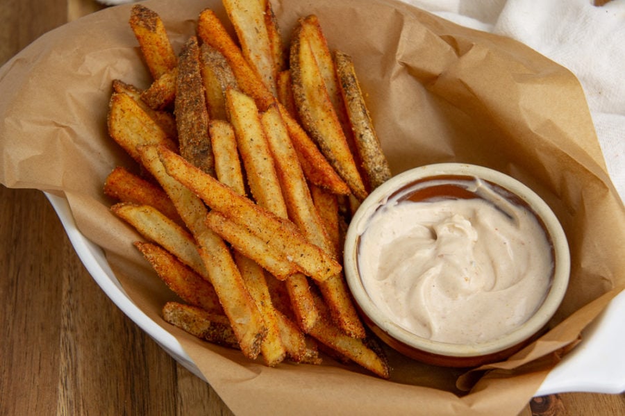 a basket of cajun fries with aioli