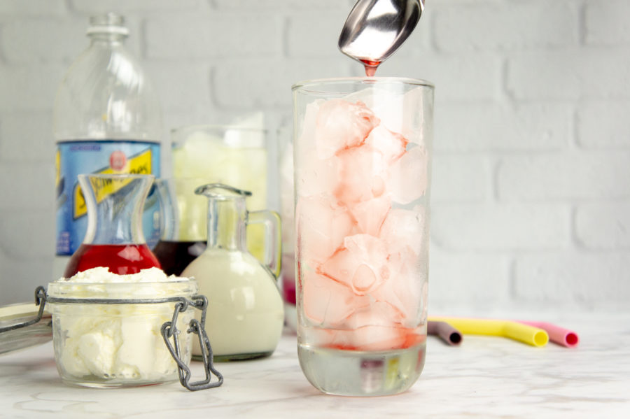 simple syrup for italian soda being poured over ice