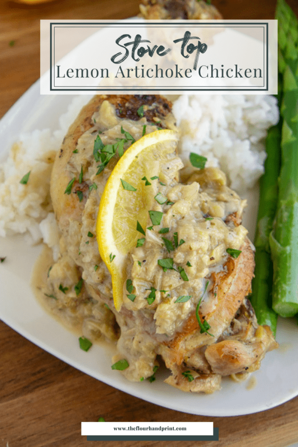 a chicken piece on a white plate with lemon and an artichoke sauce