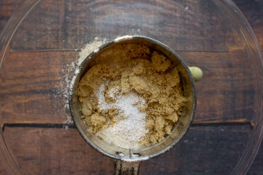 a sifter with brown sugar, salt, and flour in it
