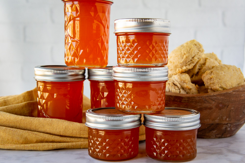 jars of jelly on a yellow linen