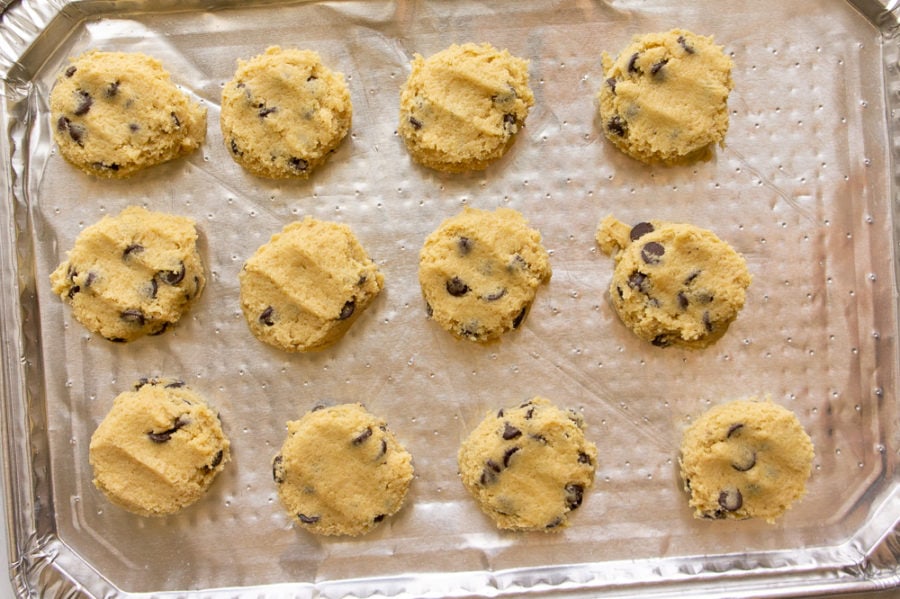 a baking sheet with chocolate chip cookie dough on it for freezing