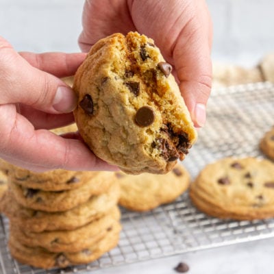 a chocolate chip cookie being broken in half