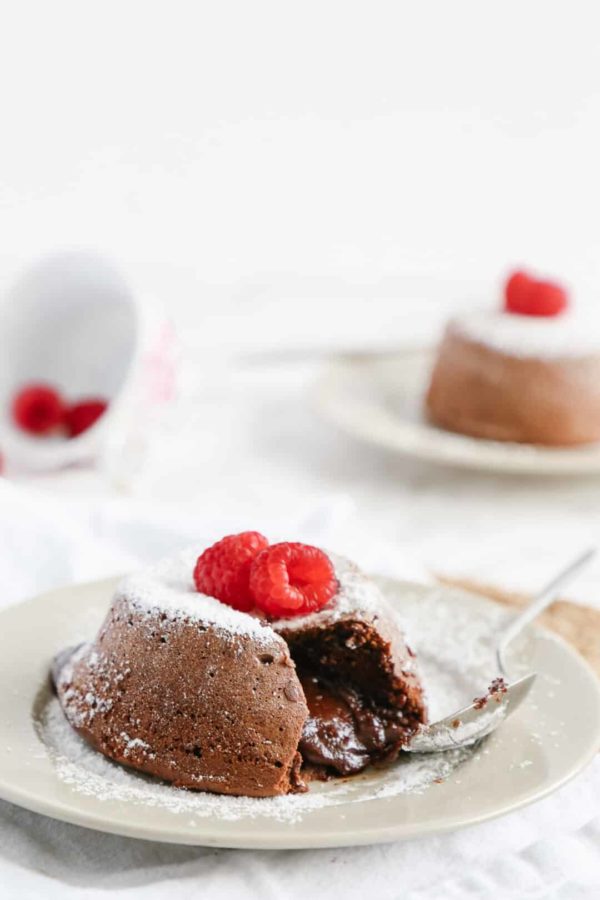 two chocolate lava cakes on white plates