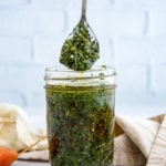 a jar and a spoon of chimichurri