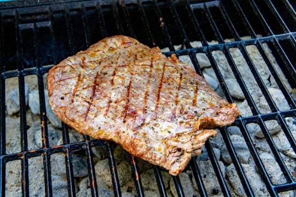 a flank steak on the grill