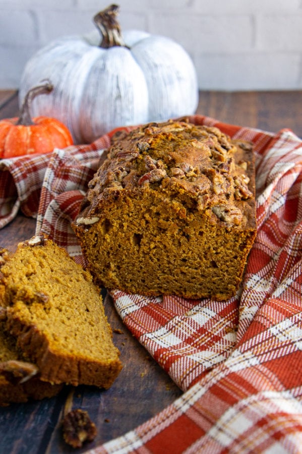 healthy pumpkin bread loaf on a orange checked towel