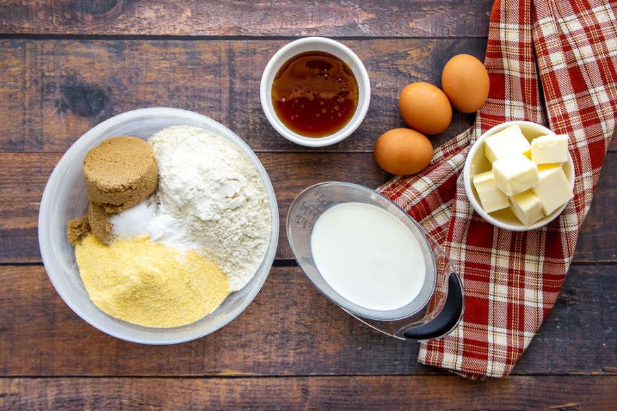 ingredients for honey butter cornbread on a wood table