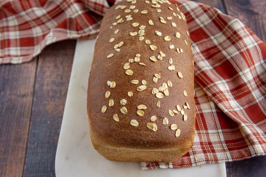 A baked loaf of honey wheat bread