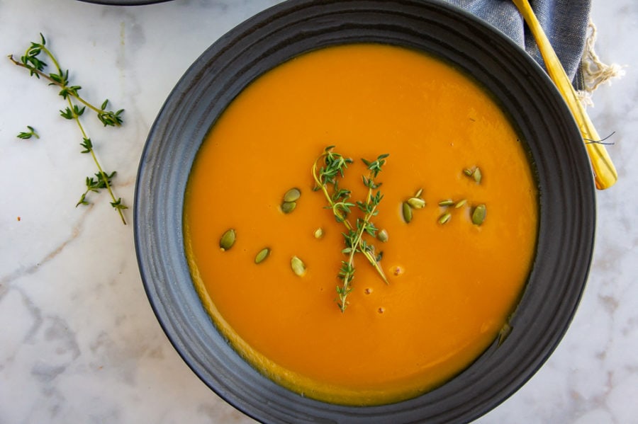 a bowl of honeynut squash soup