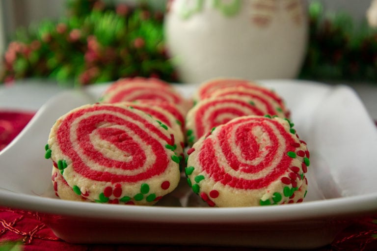 red and white swirled sugar cookies on a white plate