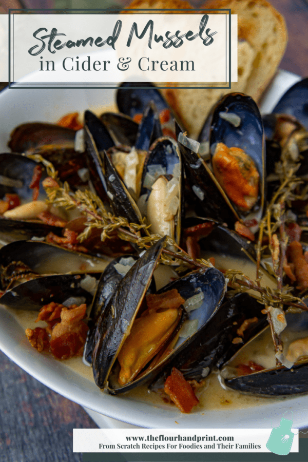 white bowl with mussels, bacon, and thyme in cider cream