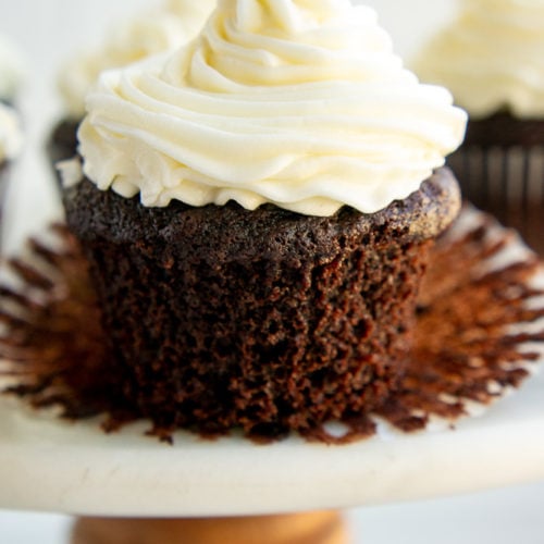 chocolate cupcake with vanilla buttercream on an open liner