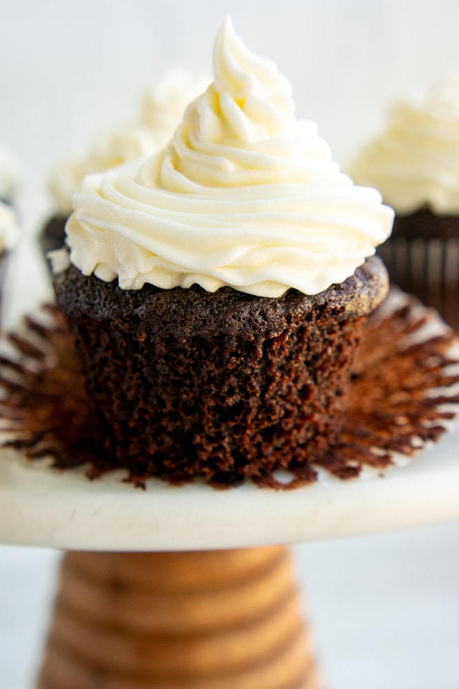 chocolate cupcake with vanilla buttercream on an open liner