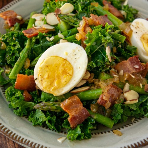 warm asparagus salad with kale, hard boiled eggs, and bacon dressing