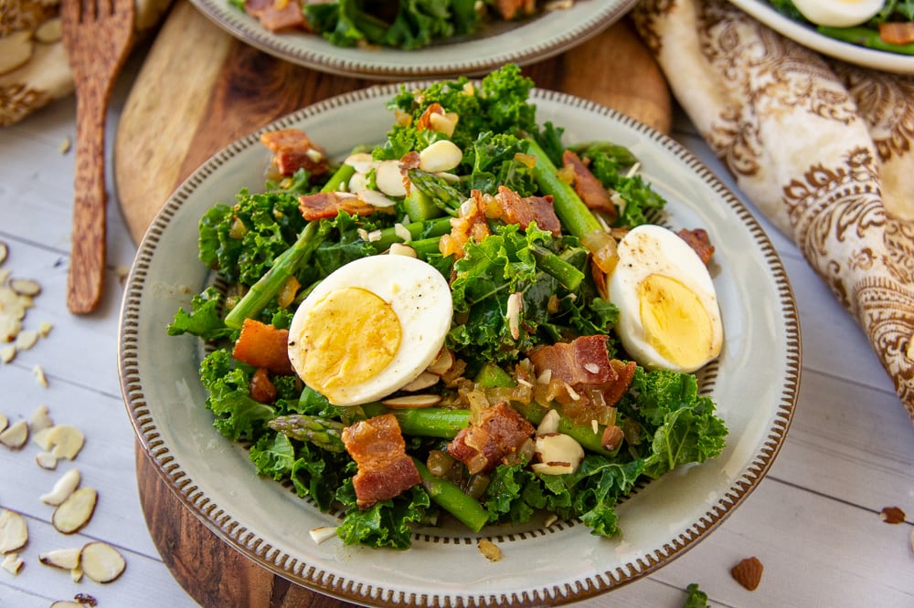 plate of warm kale and asparagus salad with hard cooked eggs