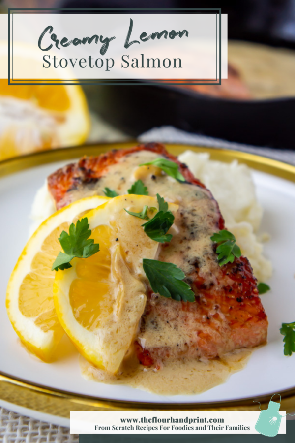 salmon with a creamy lemon sauce and slice of lemon on plate