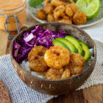 a bowl of rice, shrimp, avocado, and slaw