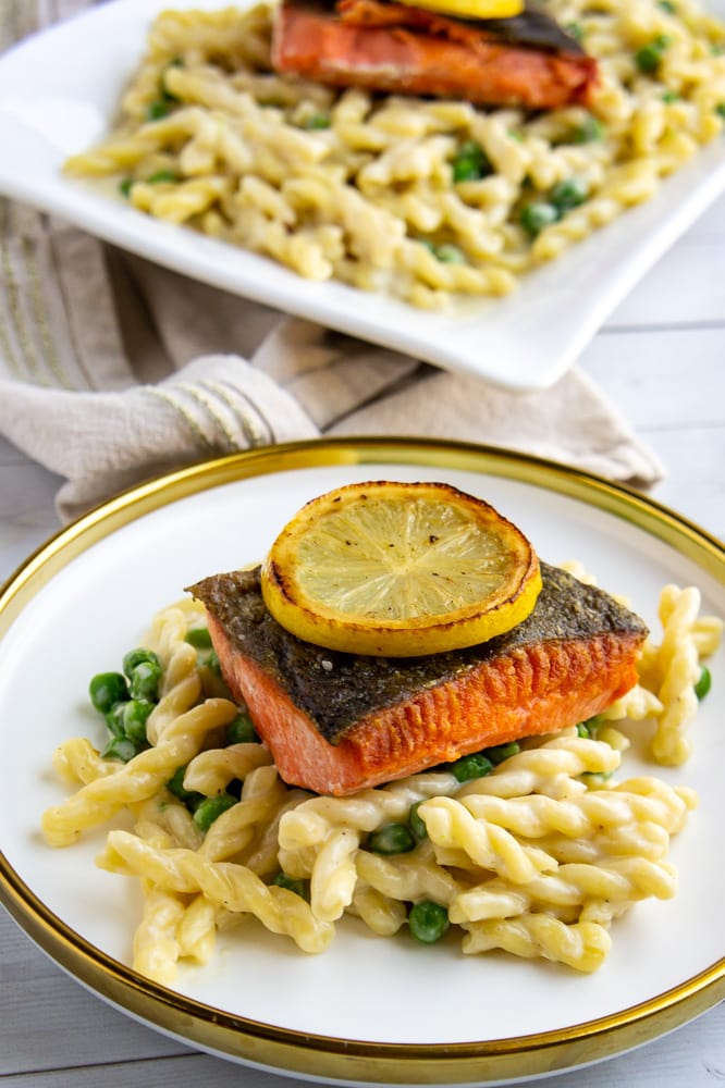 a plate of creamy lemon salmon pasta with peas