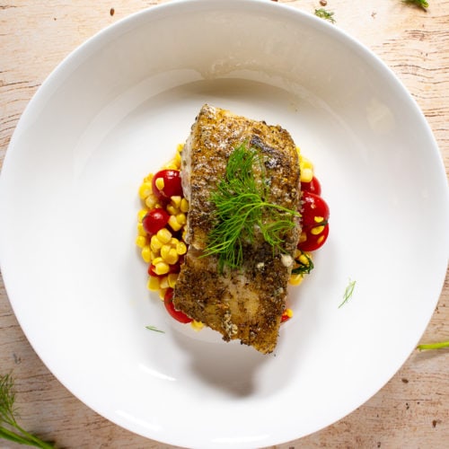 A white bowl with dill and flaxseed dill crusted cod