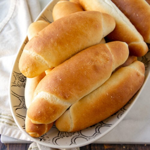 a bowl of homemade hot dog buns on a towel