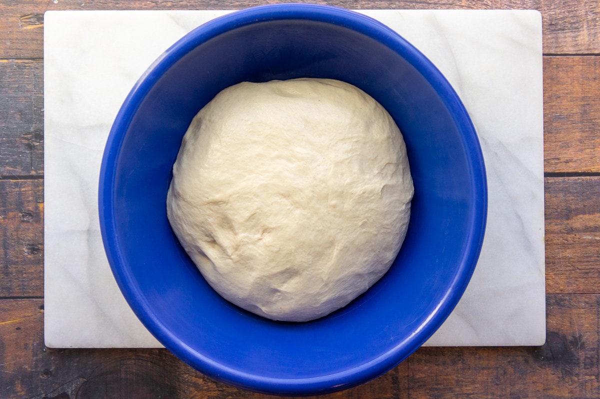 a bowl of dough for homemade buns